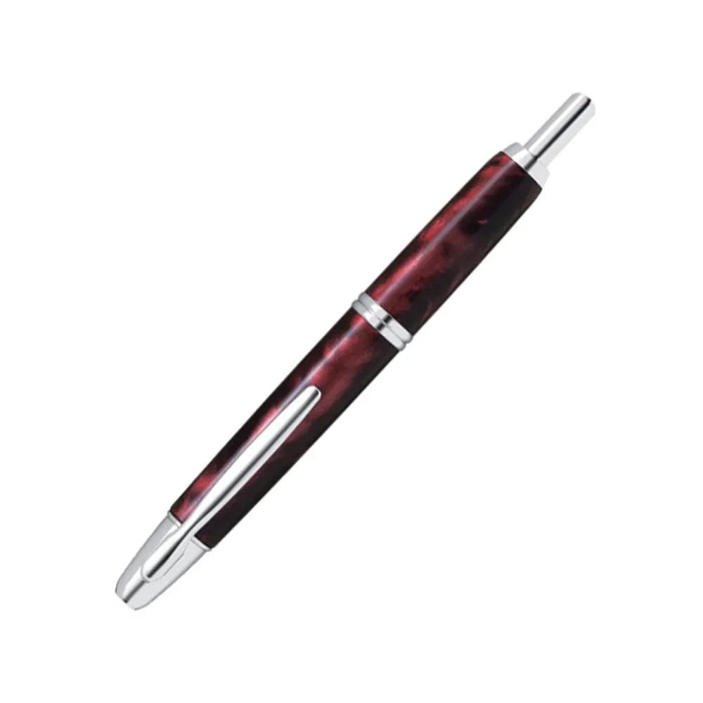 The Pilot Capless Marble Red Fountain Pen stunning and vibrant marble-colored Red resin body extends sophistication to your writing style. Every single pen is one-of-a-kind because no two marbling patterns are the same. Designed to delight the fountain pen collector, the pen’s exceptional body is enhanced with lustrous rhodium accents. The Capless fountain pen by Pilot is the world’s first and favorite retractable fountain pen. The Vanishing Point was revolutionary when it was engineered in 1963 and continu