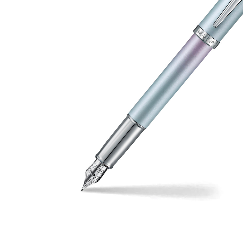 This fountain pen captures the essence of modern self-expression - fearless, fluid, and entirely original. With a vibrant pearlised gradient shifting from blue to pink and sleek chrome-plated trims, it's crafted for those who write their own rules. Engineered with Sheaffer's signature smoothness, the VFM Expression isn't just a pen, it's a statement of individuality in motion.
