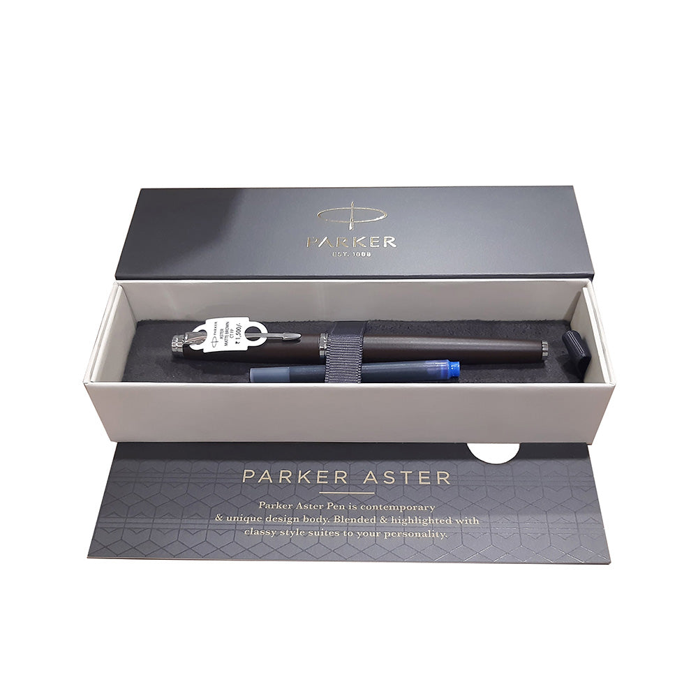 Parker Aster Fountain Pen With Matt Brown Finish Metal Barrel And Chrome Plated Trim. A Contemporary & Unique Design Blended Highlighted With A Chrome Plated Ring On The Barrel. Body : Matte Brown with Chrome-plated Trim Pen opening mechanism: Cap off/ cap on Stainless Steel Medium Nib A contemporary and unique design blended highlighted with a chrome plated ring on the barrel Country of Origin: India