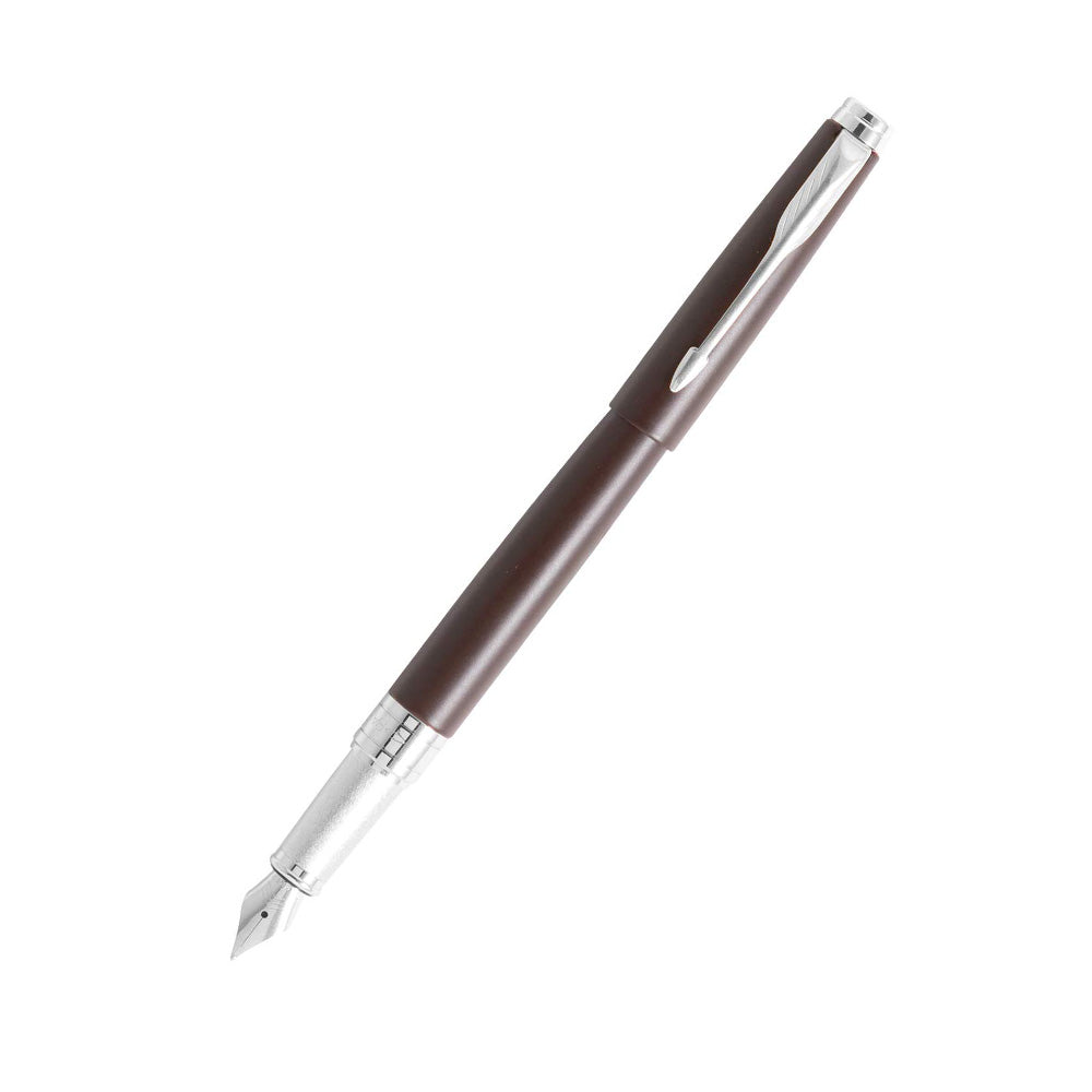 Parker Aster Fountain Pen With Matt Brown Finish Metal Barrel And Chrome Plated Trim. A Contemporary & Unique Design Blended Highlighted With A Chrome Plated Ring On The Barrel. Body : Matte Brown with Chrome-plated Trim Pen opening mechanism: Cap off/ cap on Stainless Steel Medium Nib A contemporary and unique design blended highlighted with a chrome plated ring on the barrel Country of Origin: India
