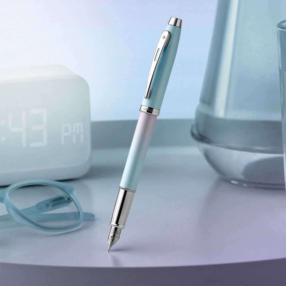 This fountain pen captures the essence of modern self-expression - fearless, fluid, and entirely original. With a vibrant pearlised gradient shifting from blue to pink and sleek chrome-plated trims, it's crafted for those who write their own rules. Engineered with Sheaffer's signature smoothness, the VFM Expression isn't just a pen, it's a statement of individuality in motion.